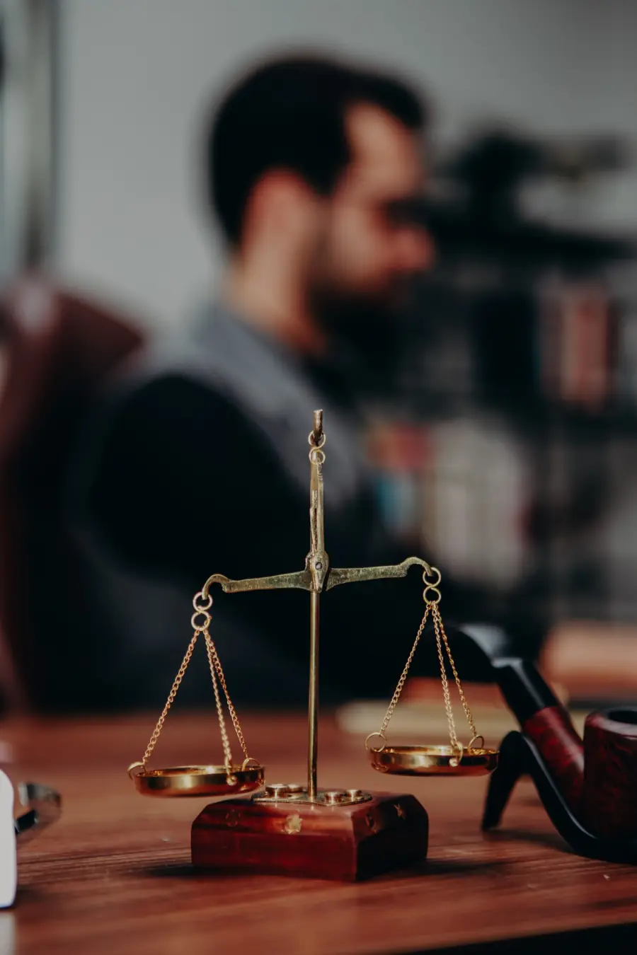 Brass scales of justice on an attorney's desk